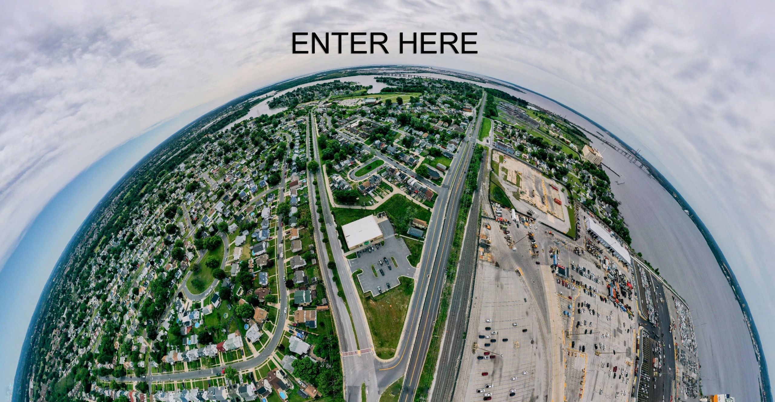 Aerial fisheye view of suburban landscape — click to enter virtual tour